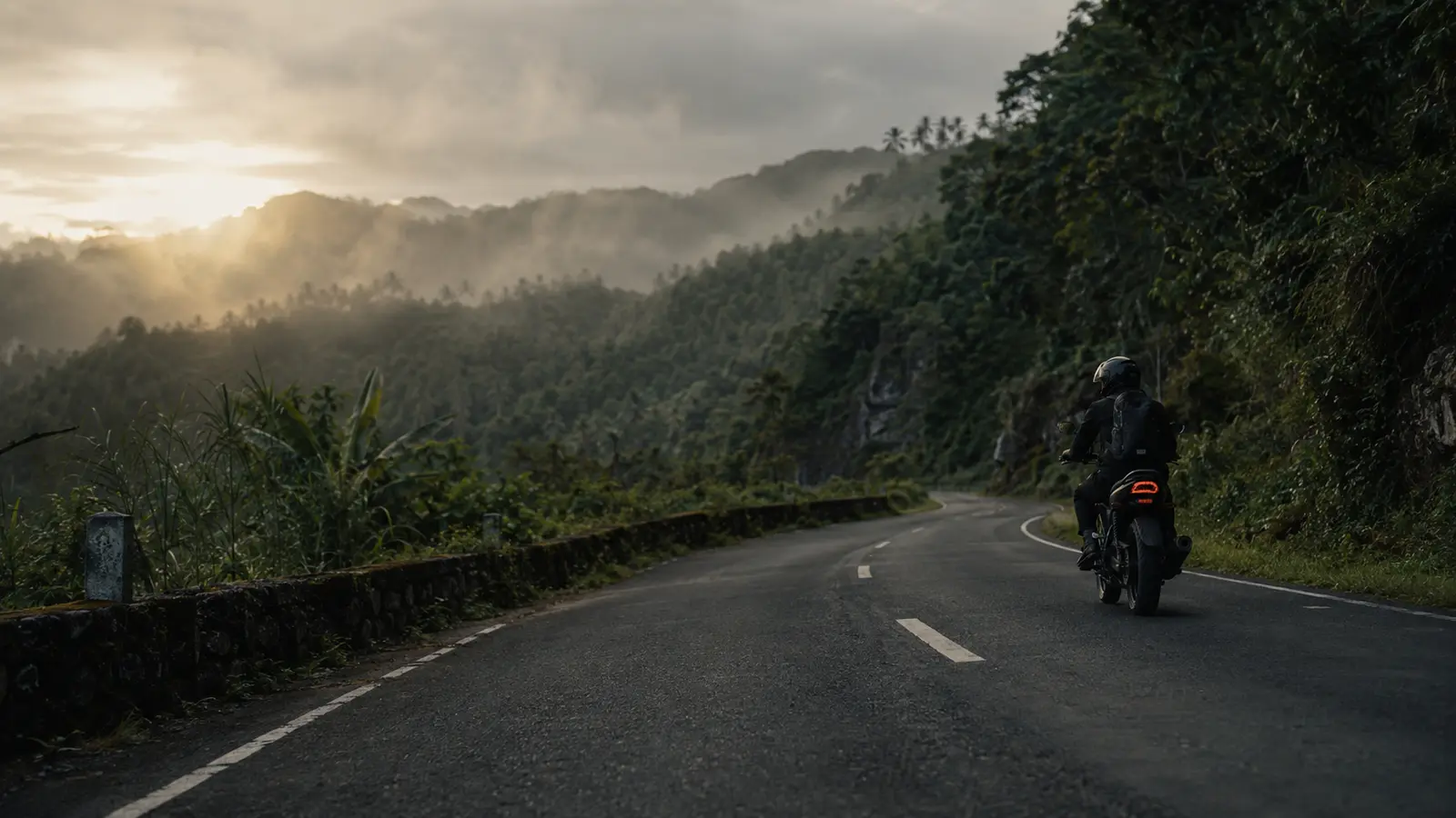 A rider following a mountain road in the Philippines
